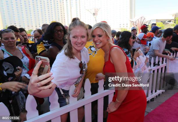 Network host Kathryn Tappen poses for a selfie photo as she arrives on the magenta carpet for the 2017 NHL Awards at T-Mobile Arena on June 21, 2017...