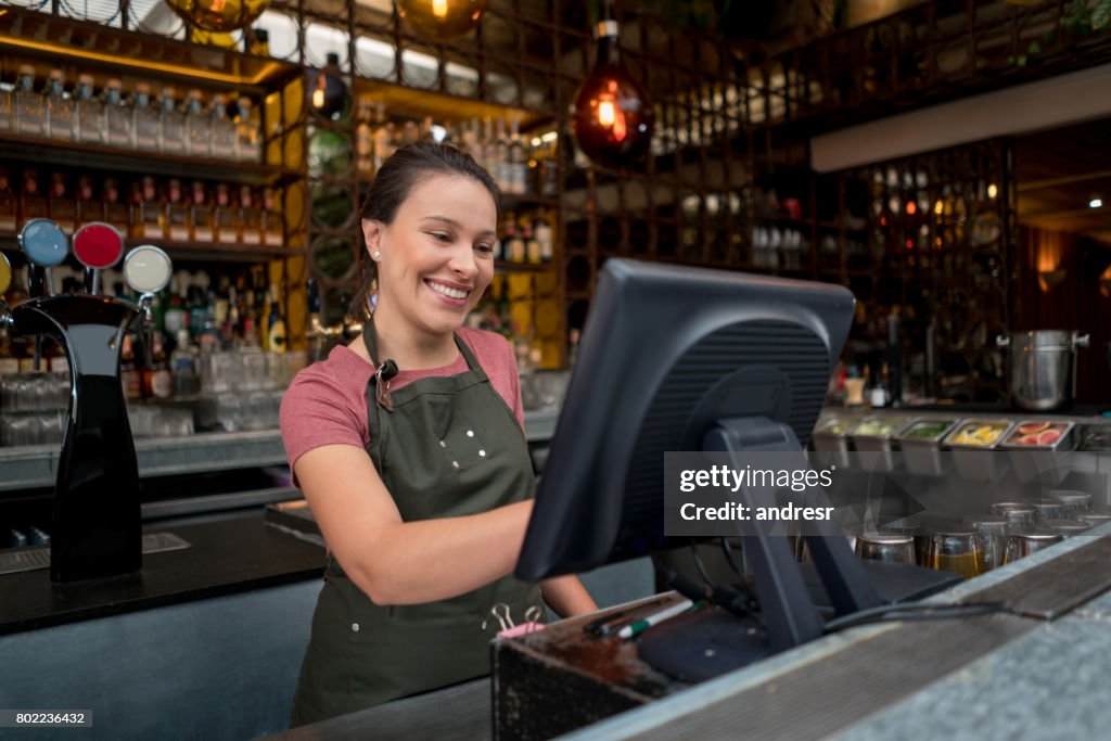 Waitress Placing An Order On The Computer At A Bar High-Res Stock Photo ...