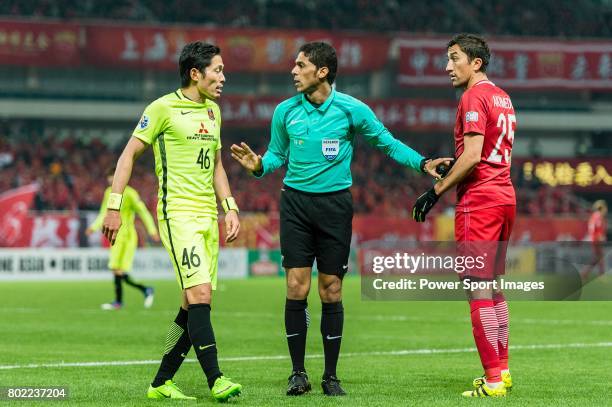 Fifa Referee Fahad Almirdasi of Saudi Arabia talks with Urawa Reds Defender Moriwaki Ryota and Shanghai FC Midfielder Akhmedov Odil during the AFC...