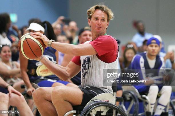 Olympic Swimmer Aaron Peirsol looks to pass to the open player during the 3rd Annual Celebrity Wheelchair Basketball Game at the John Wooden Center...