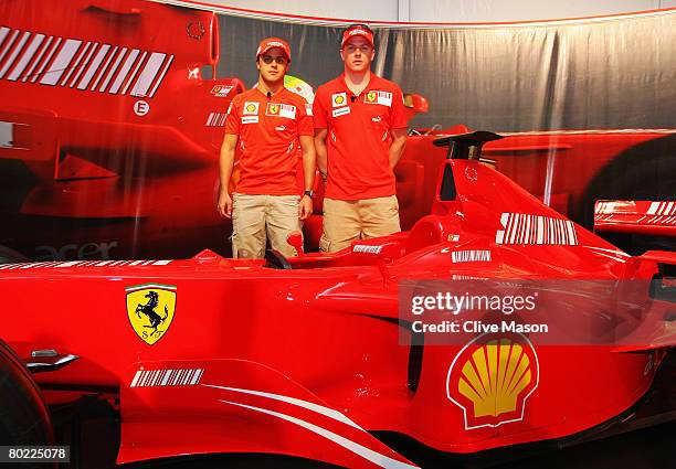 Ferrari drivers Felipe Massa of Brazil and Kimi Raikkonen of Finland pose for photographers at a press conference during previews for the Australian...