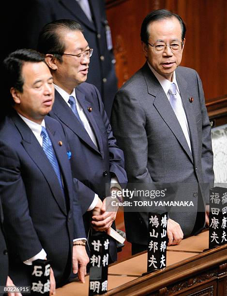 Beside Economy, Trade and Industry Minister Akira Amari and Justice Minister Kunio Hatoyama , Japanese Prime Minister Yasuo Fukuda stands up to vote...