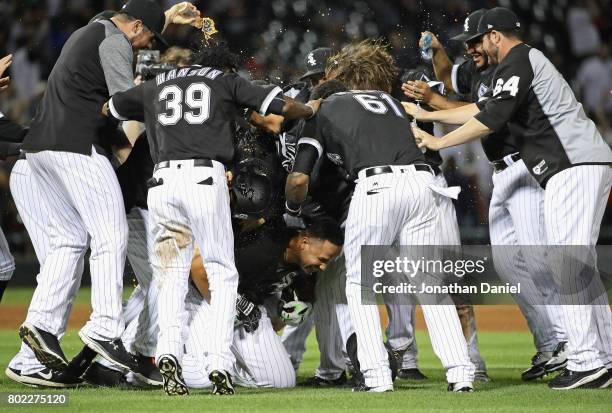 Jose Abreu of the Chicago White Sox is mobbed by teammates after hitting a two run, game winning double in the 9th inning against the New York...