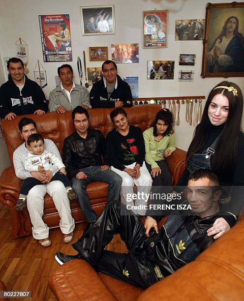 Hungarian flyweight boxer Norbert Kalucza poses with his pregnant 17 year-old fiancee Vivien and his family in their house in Debrecen, eastern...