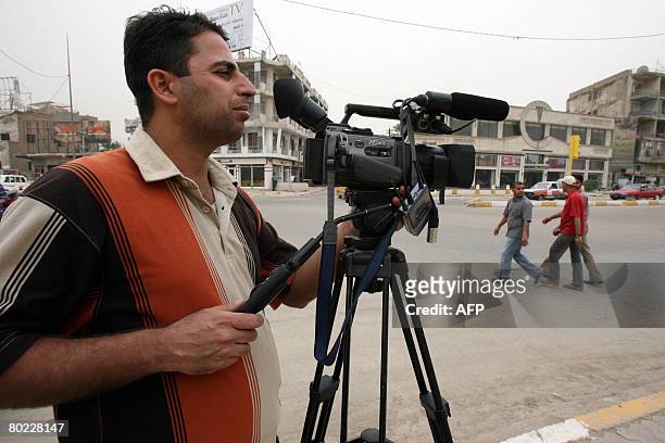 An Iraqi cameraman shoots with his camera in central Baghdad on March 11, 2008. Freedom of the press flourished after Saddam Hussein's tight grip on...