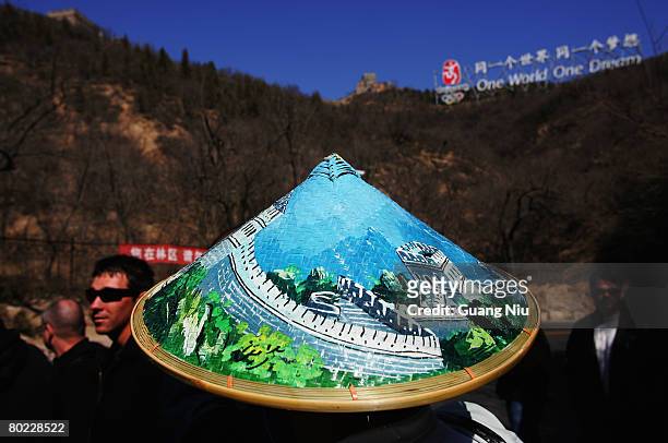 San Diego Padres baseball player wears a souvenir hat during a trip of the Great Wall March 13, 2008 on the outkirt of Beijing, China. The San Diego...