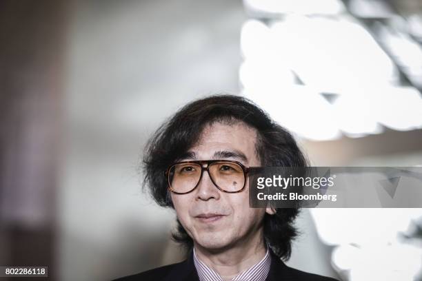 Yoshiyuki Sankai, founder and president of Cyberdyne Inc., listens during a Bloomberg Television interview on the sidelines of the World Economic...