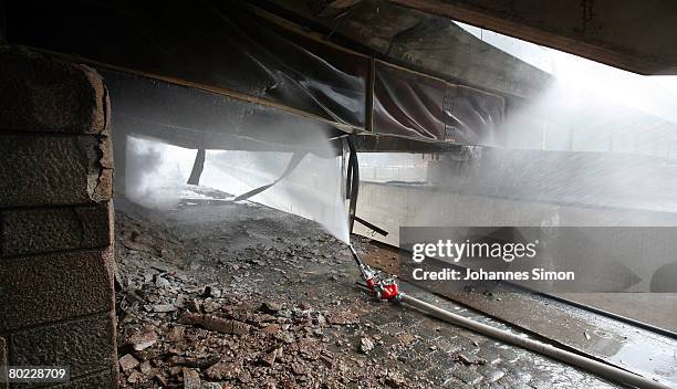 Fire is fighted by the Regensburg firebrigade under Protzenweiher Brigde on March 13, 2008 in Regensburg, Germany. The fire caused heavy damages to...