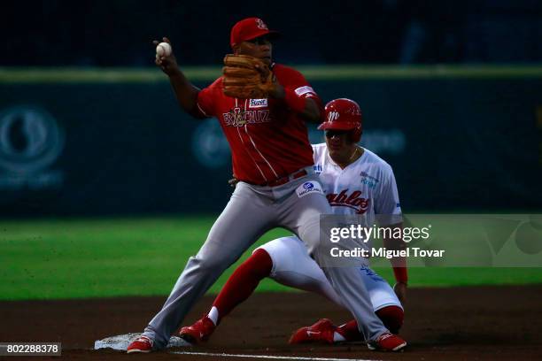 Jesus Lopez of Diablos is tagged out in third base during the match between Rojos del Aguila and Diablos Rojos as part of the Liga Mexicana de...