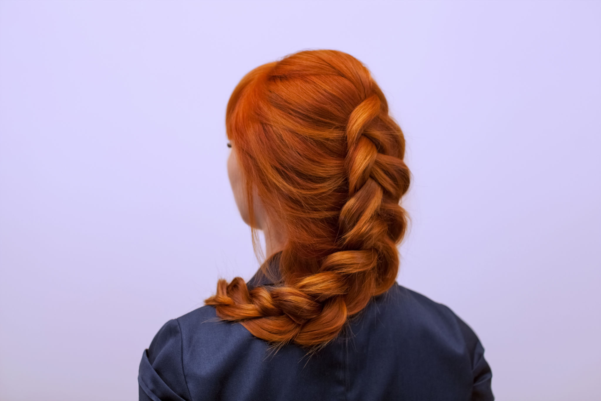 Beautiful girl with long red hair, braided with a French braid, in a beauty salon. Beautiful girl with long red hair, braided with a French braid, in a beauty salon.
