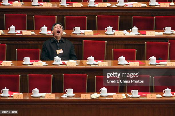 Delegate yawns as he attends the fourth plenary meeting of the CPPCC at the Great Hall of the People on March 13, 2008 in Beijing, China. Jia Qinglin...