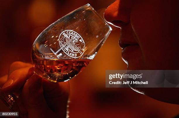 Andrew Kirk, a malt advocate, noses a glass of whisky at Glenkinchie distillery March 13, 2008 in Edinburgh, Scotland. Chancellor Alistair Darling...