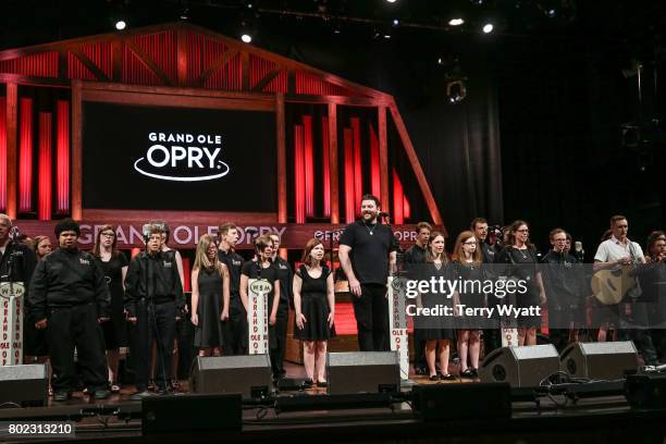 Lifting Lives music Campers join Singer-songwriter Chris Young on stage during a Performance at Grand Ole Opry House on June 27, 2017 in Nashville,...