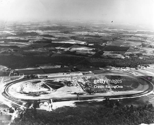 An aerial view of the brand new Darlington Raceway in 1950. Note the passenger bridge over the original backstretch and Sherman Ramsey's Pond near...