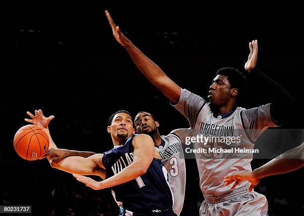 Scottie Reynolds of the Villanova Wildcats goes to the hoop and is fouled against DaJuan Summers and Roy Hibbert of the Georgetown Hoyas during day...