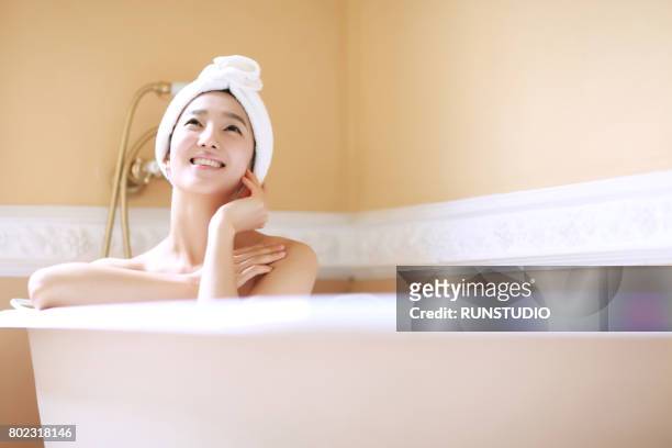 woman in bathtub - japanese women bath stock pictures, royalty-free photos & images