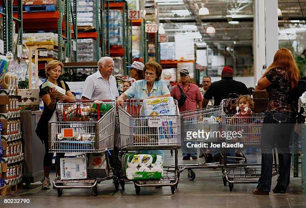 Michael Kaire and Sylvia Kaire and others shop at a Costco store March 13, 2008 in North Miami, Florida.The Commerce Department released a report...