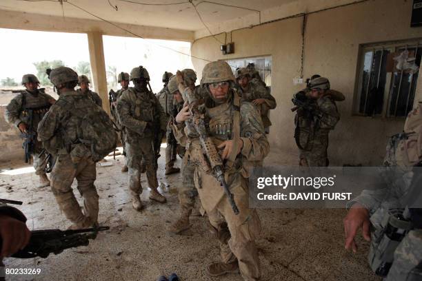 Soldiers from Ghostrider Company 3rd Squadron 2nd Stryker Cavalry Regiment prepare to set out on a foot patrol after occupying an Iraqi home for the...