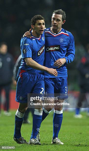 Carlos Cuellar and David Wier of Rangers celebrate an aggregate win during the UEFA Cup Round of 16 second leg match between Werder Bremen and...