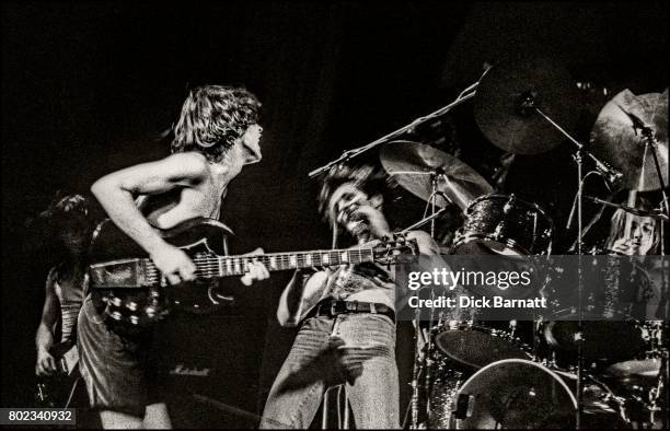 Angus Young and Bon Scott of AC/DC performing on stage, Lyceum Theatre, London, United Kingdom on July 7, 1976 from the Lock Up Your Daughters Tour.