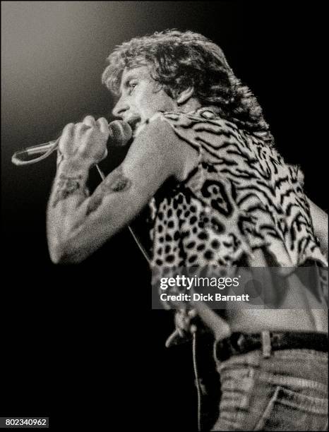 Bon Scott of AC/DC performing on stage, Lyceum Theatre, London, United Kingdom on July 7, 1976 from the Lock Up Your Daughters Tour.