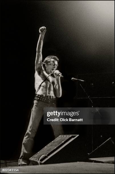 Bon Scott of AC/DC performing on stage, Lyceum Theatre, London, United Kingdom on July 7, 1976 from the Lock Up Your Daughters Tour.