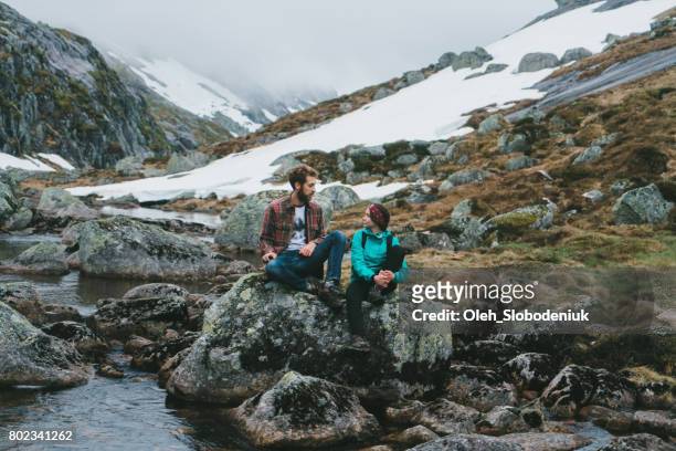 woman and man hiking in mountains in norway - northpark stock pictures, royalty-free photos & images