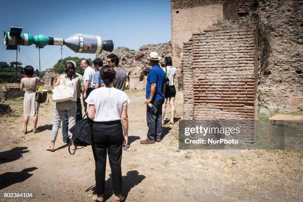 Visitors look an installation by artist Christian Philipp Muller titled &quot;Space randez-vous&quot; on June 27, 2017 at the Palatine Hill in Rome...