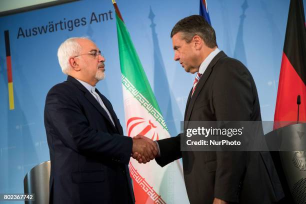 German Vice Chancellor and Foreign Minister Sigmar Gabriel and Iranian Foreign Minister Mohammad Javad Zarif shake hands at the end of a news...