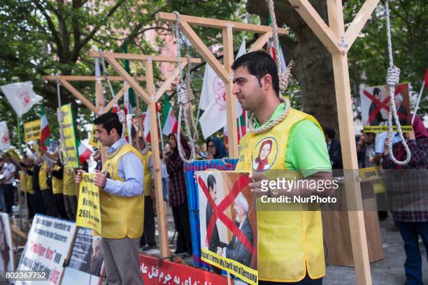 People protest during the meeting between German Vice Chancellor and Foreign Minister Sigmar Gabriel and Iranian Foreign Minister Mohammad Javad...