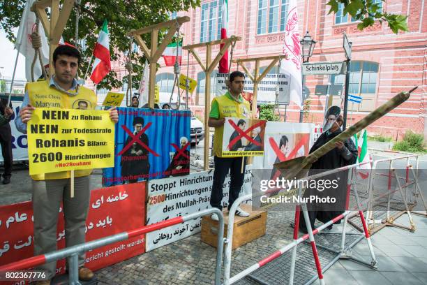 People protest during the meeting between German Vice Chancellor and Foreign Minister Sigmar Gabriel and Iranian Foreign Minister Mohammad Javad...