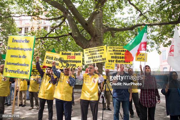 People protest during the meeting between German Vice Chancellor and Foreign Minister Sigmar Gabriel and Iranian Foreign Minister Mohammad Javad...