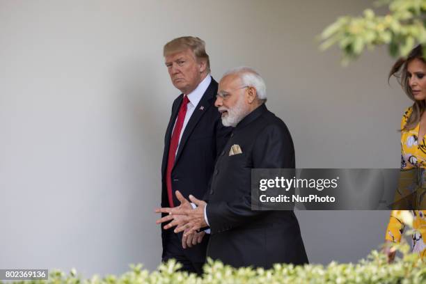 , President Donald Trump, Prime Minister Narendra Modi of India, and First Lady Melania Trump, walk down the West Wing Colonnade, on the way to the...