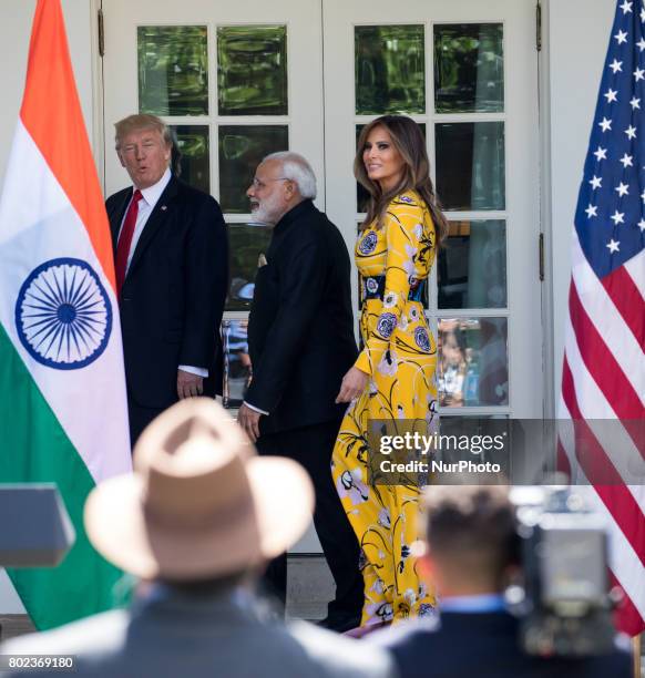 , President Donald Trump, Prime Minister Narendra Modi of India, and First Lady Melania Trump, walk down the West Wing Colonnade, on the way to the...