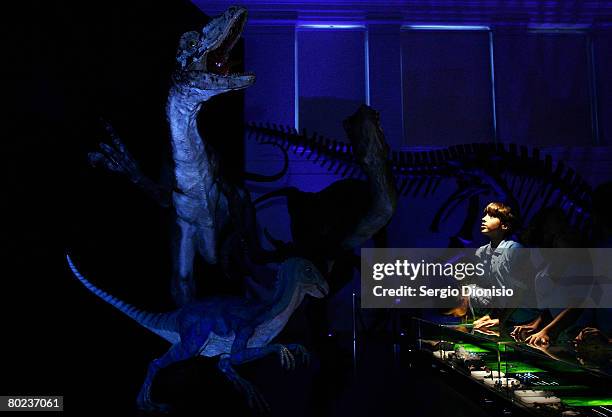 Young boy views one of 10 complete dinosaur skeletons during a new exhibition titled Dinosaurs at the Australian Museum on March 14, 2008 in Sydney,...