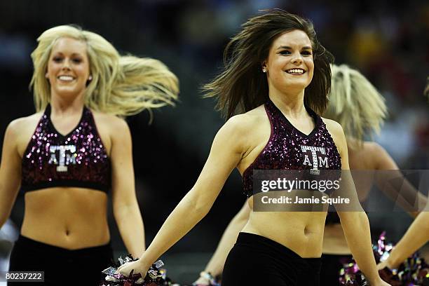 The Texas A&M Aggies cheerleaders dance during a timeout in the game against the Iowa State Cyclones on day 1 of the Big 12 Men's Basketball...