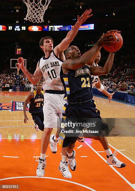 Jerel McNeal of the Marquette Golden Eagles goes to the net against Luke Zeller ofthe Notre Dame Fighting Irish during day two of the 2008 Big East...