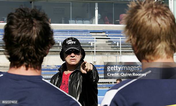 Gene Simmons of the band Kiss talks to players as he visits a Carlton Blues AFL training session held at MC Labour Park March 14, 2008 in Melbourne,...