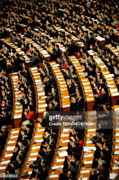 Delegates applause during the closing ceremony of the Chinese People's Political Consultative Conference at the Great Hall of the People in Beijing...