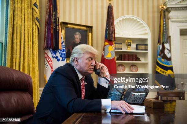 President Donald Trump talks with new Irish Prime Minister Leo Varadkar during a telephone call in the Oval Office of the White House of the White...