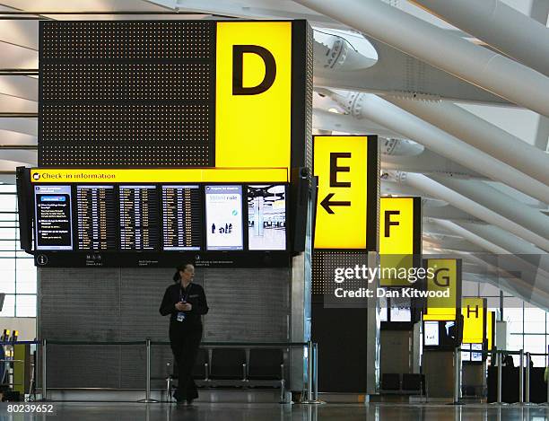 Member of staff stands in the Check-In area of the new Terminal 5 at Heathrow Airport, prior to its official opening on March 14, 2008 in London,...