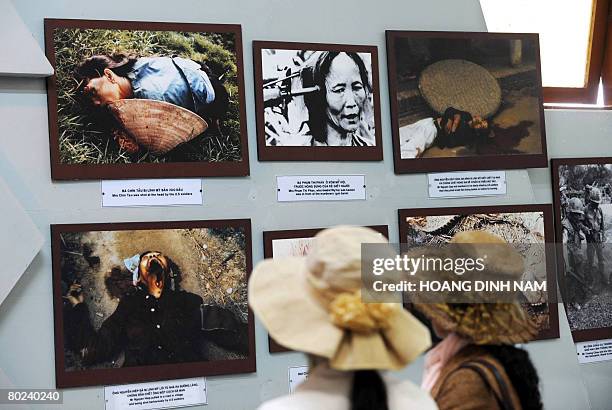 Vietnam-war-US-anniversary by Aude GenetTwo young women look at photographs showing massacre scenes as they tour the My Lai massacre museum at My Lai...