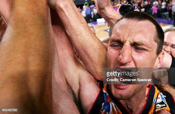 Chris Anstey of The Tigers celebrates victory with team mates after game five of the NBL Grand Final series between the Sydney Kings and the...