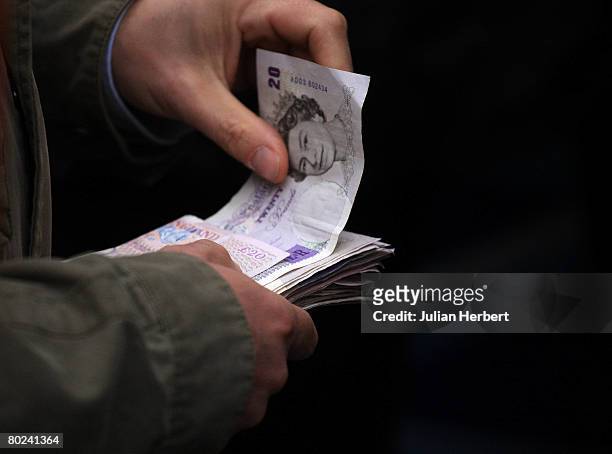 Punter hands over money for a bet at Cheltenham Racecourse on March 14 in Cheltenham, England. Today was the fourth day of The Annual National Hunt...