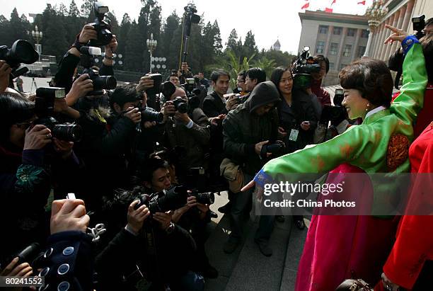 Delegate of Korean ethnic minority group, dances in front of the Great Hall of the People after the closing meeting of the First Session of 11th...