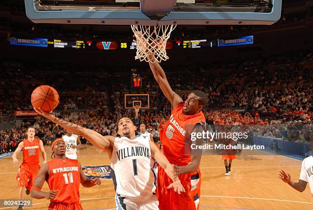 Scottie Reynolds of the Villanova Wildcats drives to the basket against Donte' Greene of the Syracuse Orange during the first round of the Big East...