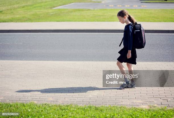 sad schoolgirl - walking to school stock pictures, royalty-free photos & images