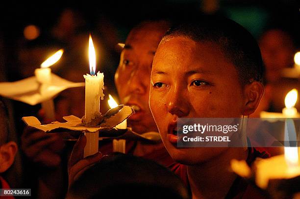 Tibetan nun in exile takes part in a candlelight vigil to show solidarity with demonstrators in Chinese-controlled Tibet, on March 14, 2008 in Mcleod...