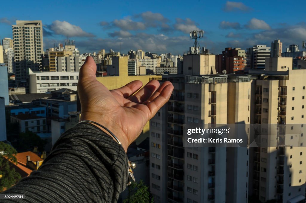 Female hand showing buildings