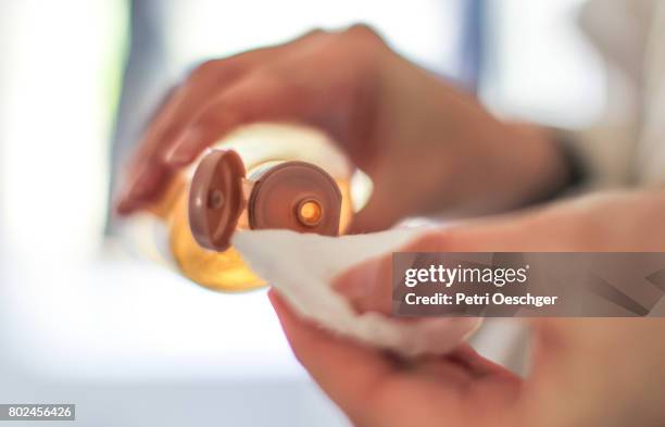 a young woman applies toner. - démaquillant photos et images de collection